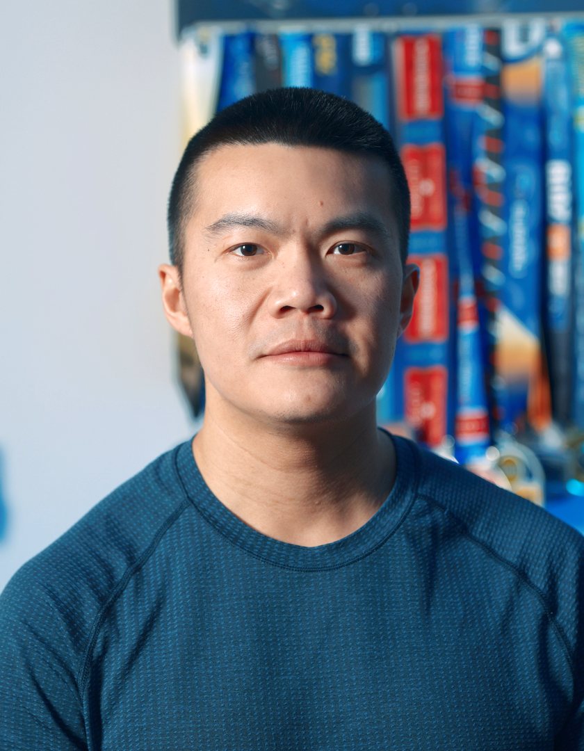Sean Chin in front of his race medals